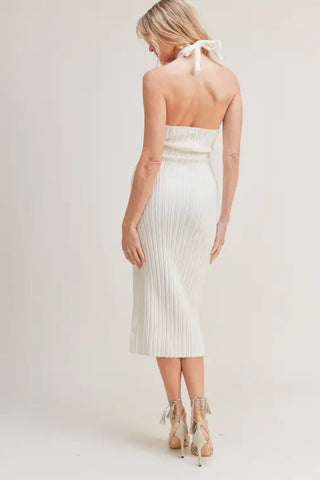 A model in Halter rib knit midi dress - Rib knit midi-dress - Tie-back halter neckline - Keyhole bust - Open back