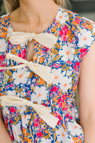Floral dress with bow details on a blurred background
