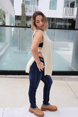 Woman standing in front of a modern building with glass walls.