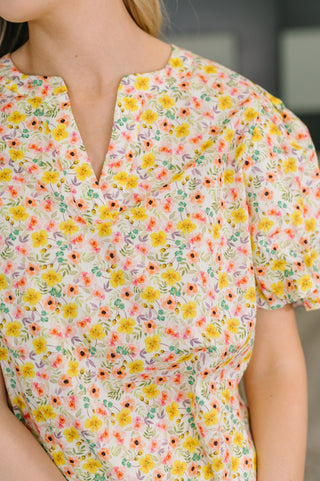 Woman wearing a floral blouse with a blurred background